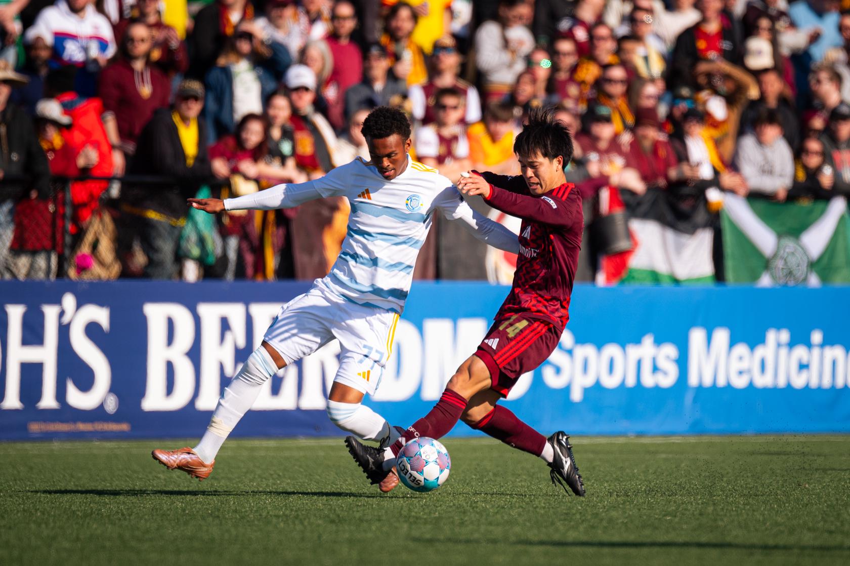 Haruki Yamazaki battles for the ball against Sporting JAX