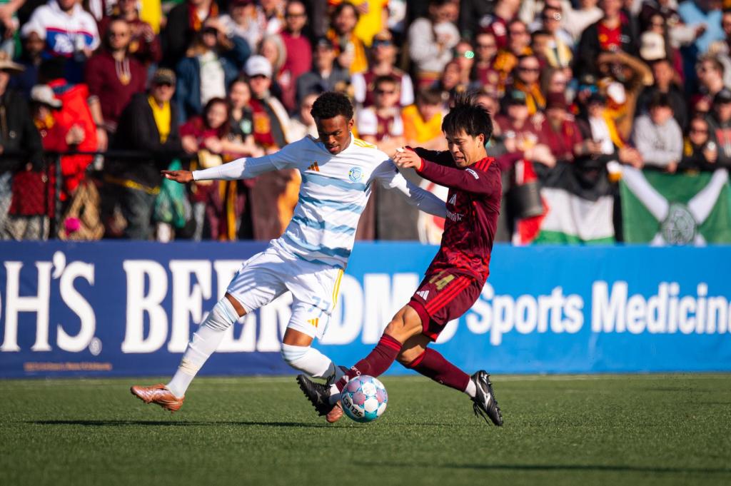 Haruki Yamazaki battles for the ball against Sporting JAX