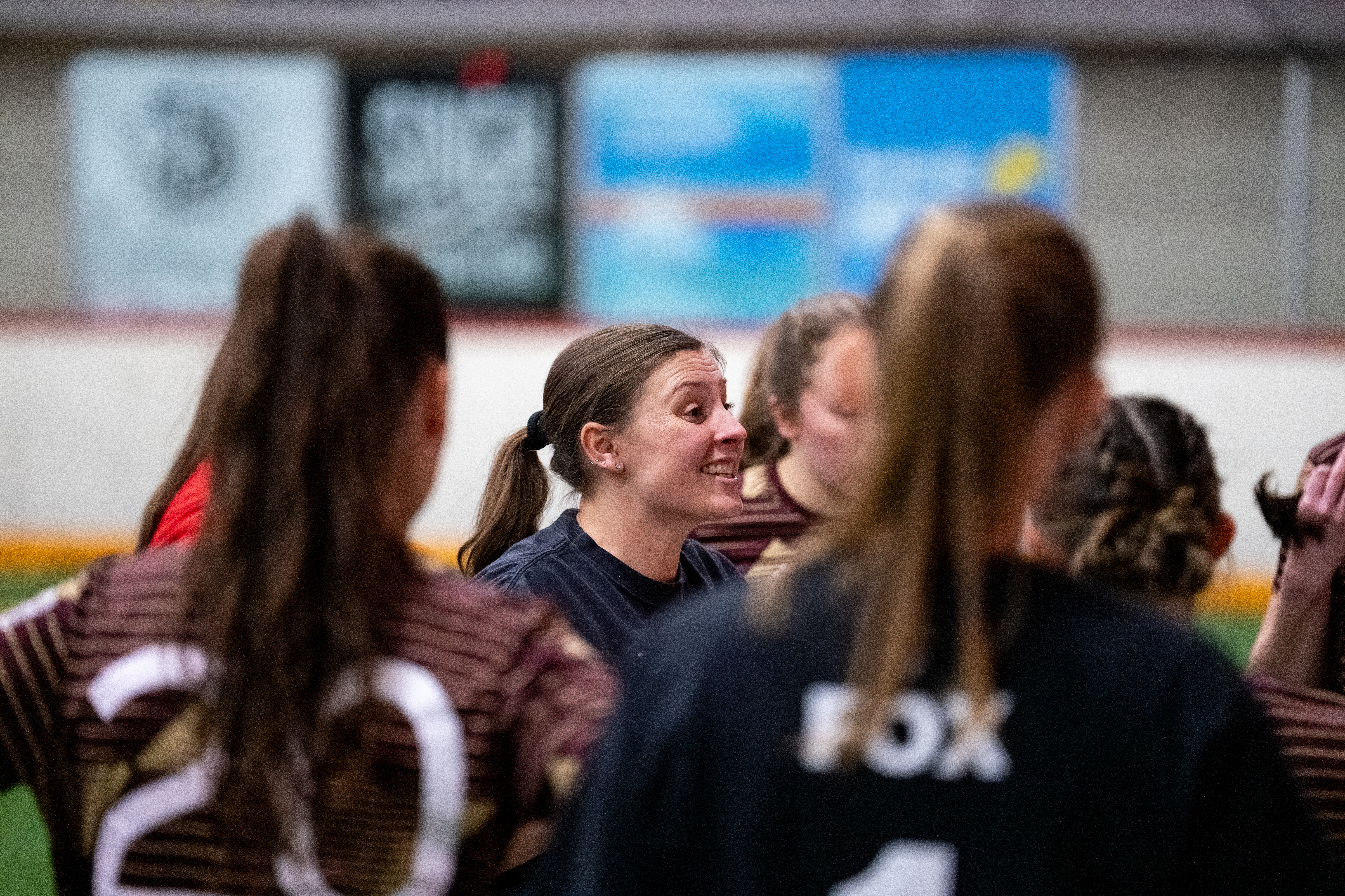 Head Coach Dani Evans smiles while leading her team's pregame meeting.