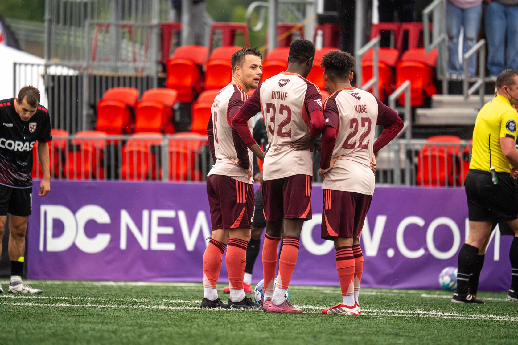Ryan Williams, Ates Diouf, and Kobe Hernandez-Foster confer during Loudoun United match