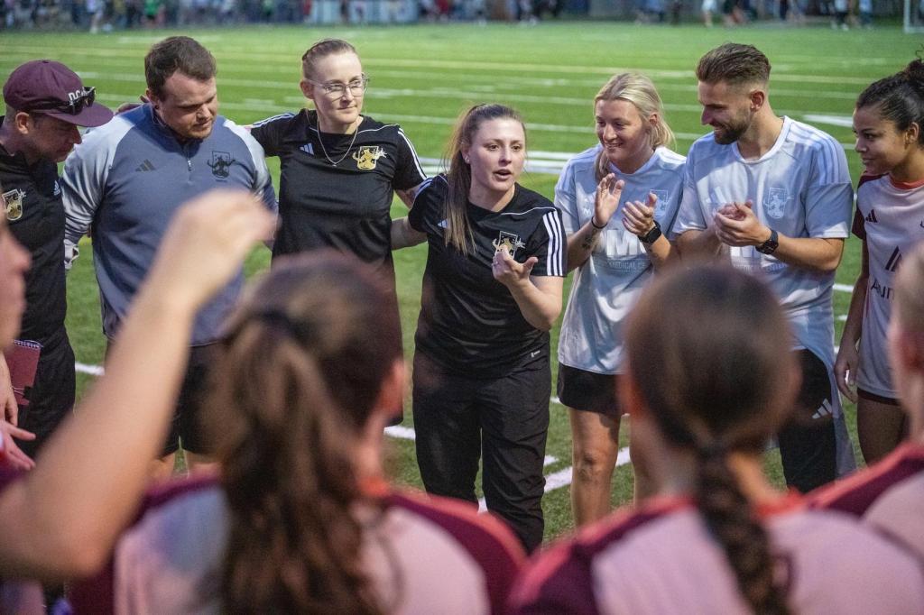 Head Coach Dani Evans talks with her W League team pregame against AFC Ann Arbor