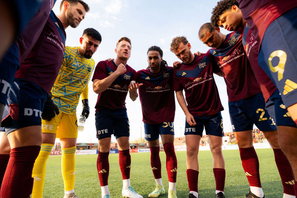 Stephen Carroll leads team huddle
