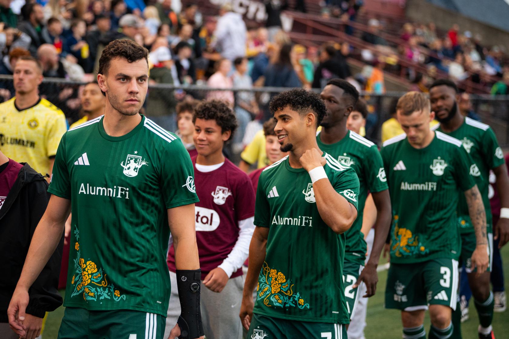 Team walk out featuring 2026 charity kit